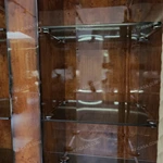 Rounded-Corner Dark Wood Wine Cabinet with Tinted Glass Doors Quilted Beige Upholstered Panels and Interior Shelving